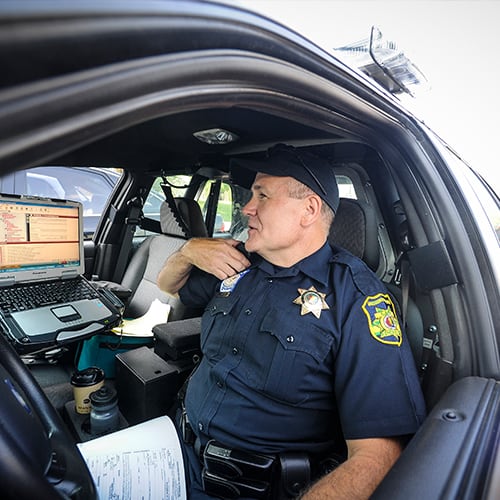 Police officer sitting in his car.