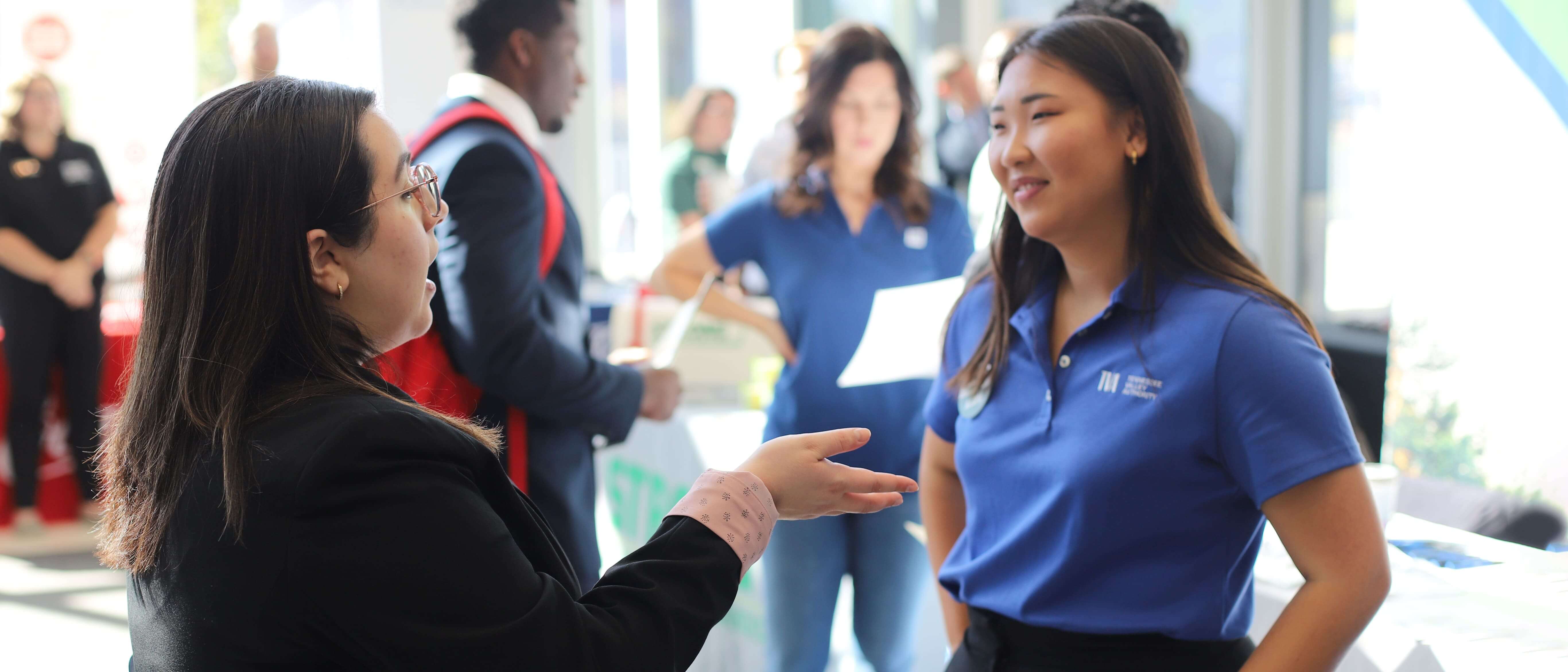 Students talking to recruiters at a Collat job fair. 