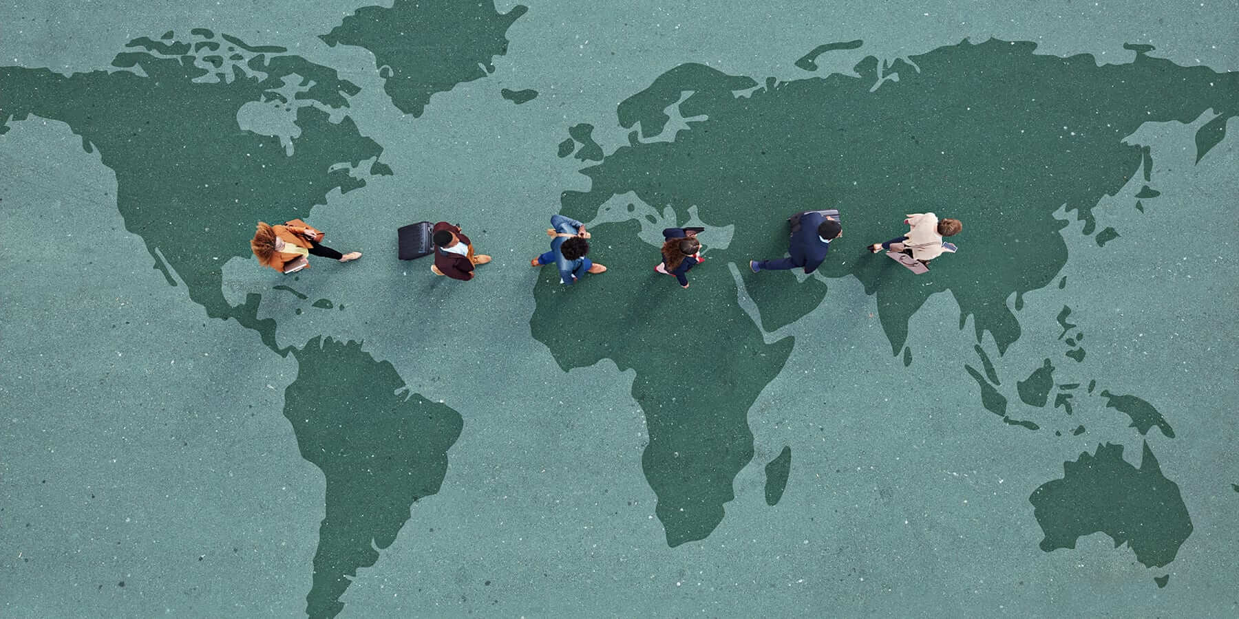 A floor that looks like a stylized map of the world, with people walking across it in a line.