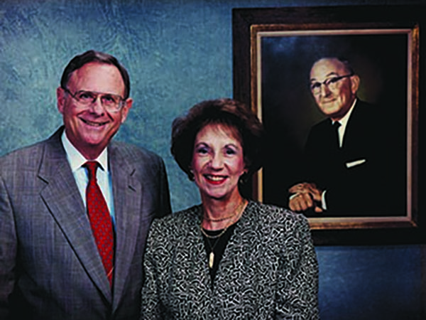 Charles and Patsy Collat with a portrait of Mayer Electric Founder Ben Weil, Patsy's father.