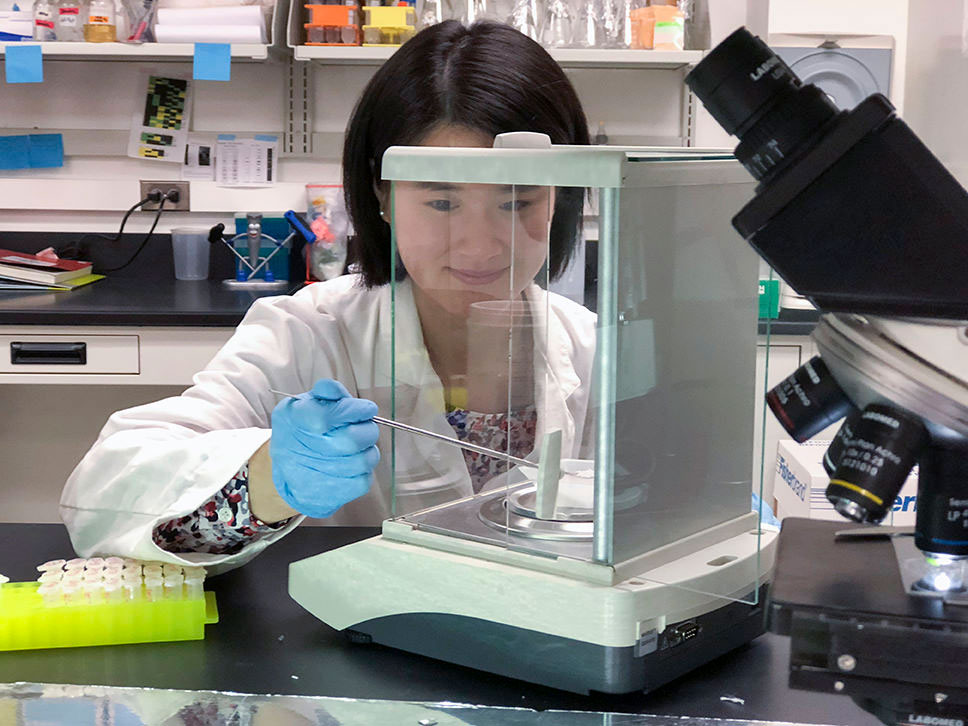 woman performing experiment in laboratory.