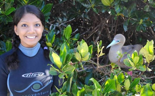 student posing with bird.