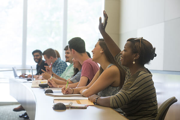 Students interacting in a classroom. 