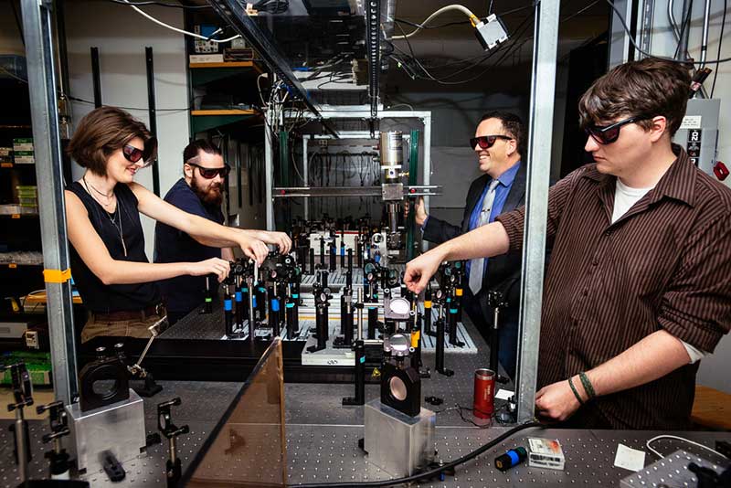 Group of people working with Hilton lasers