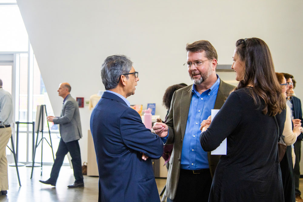 Faculty conversing at the reception.