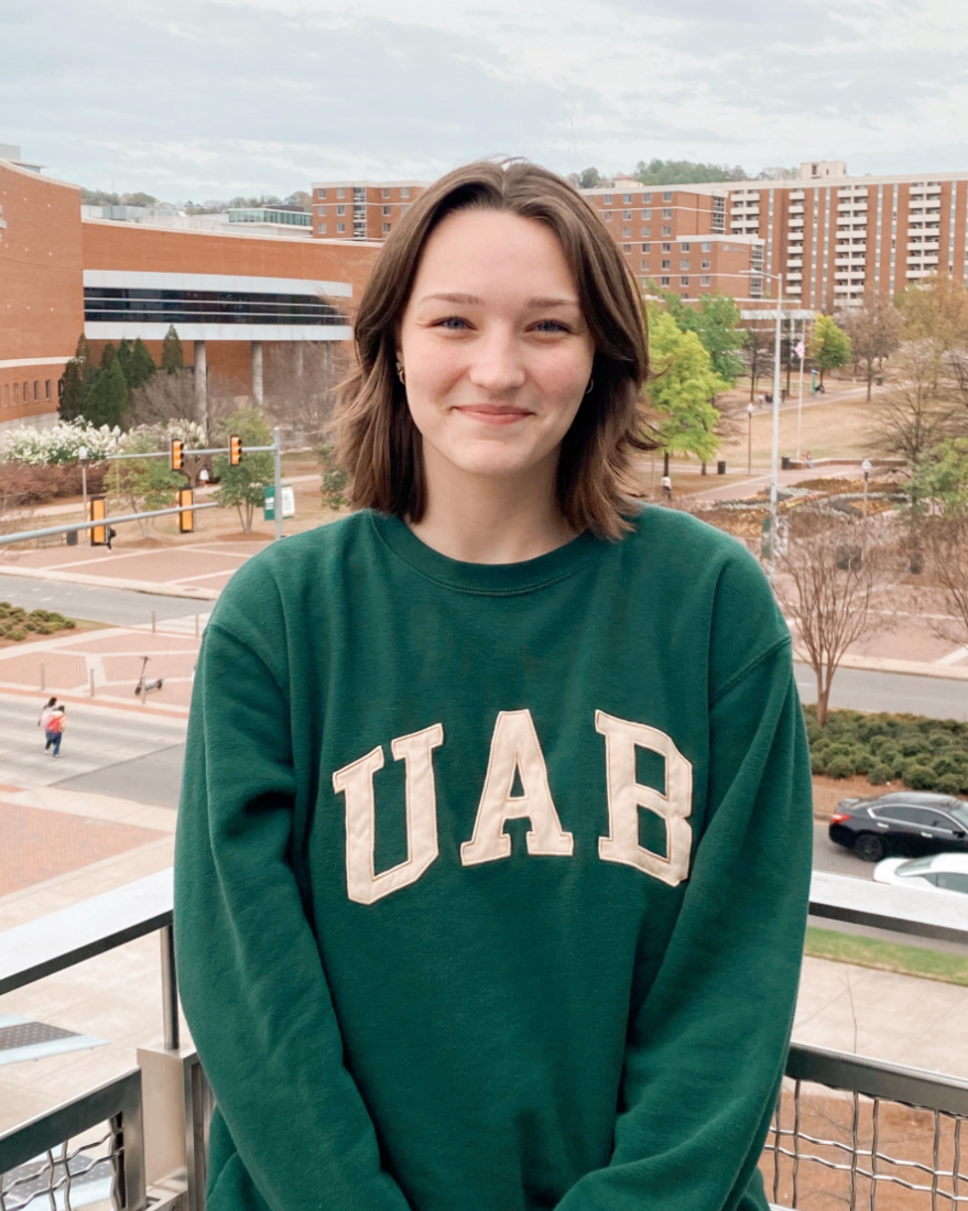 Photo of Kiersten Ratcliff standing on the Hill Student Center third floor outdoor patio