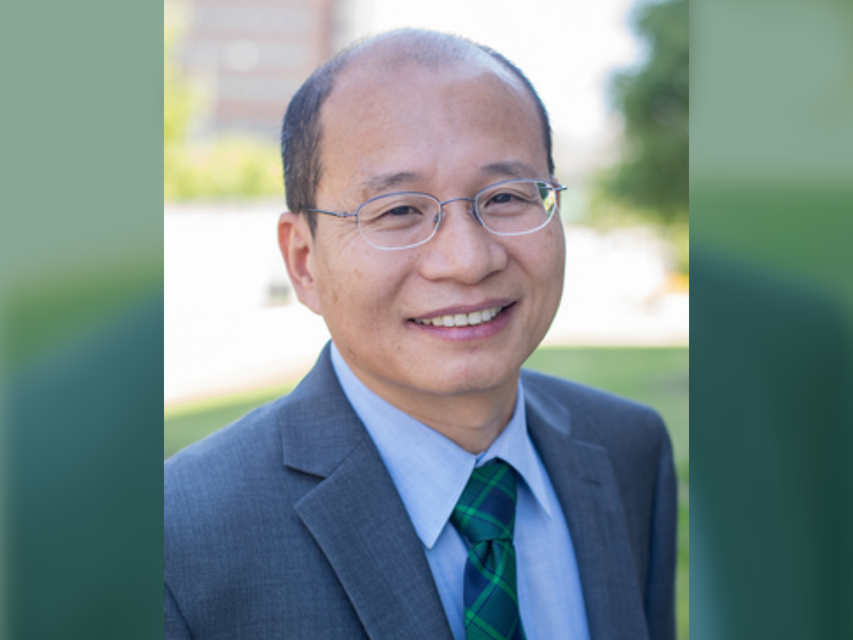 Dr. Zheng poses for a photo outdoors.