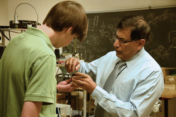 Physics professor teaching student