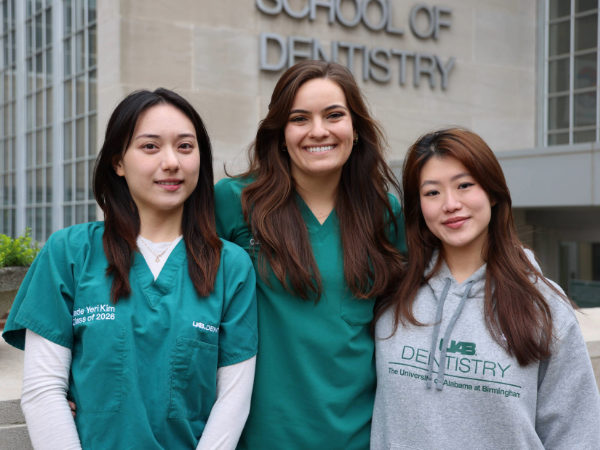 Jade Kim, Emily Joy, Luci Shin in front of the school