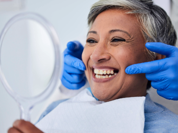 Senior woman having teeth and smile examined by a dentist. Photography Adobe Stock.