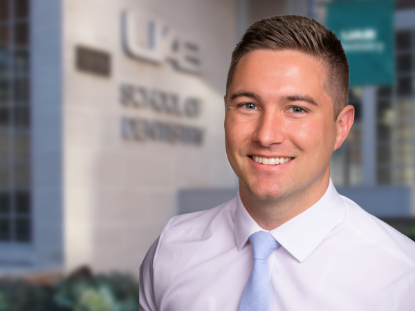 Dr. Teeples in front of the UAB School of Dentistry building