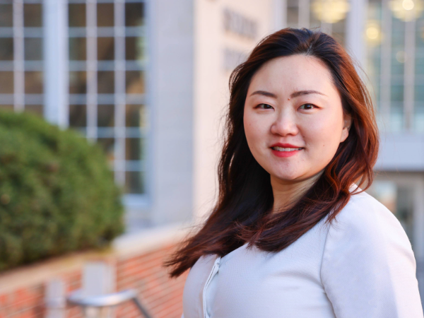 Tingxi Wu in front of the School of Dentistry Building