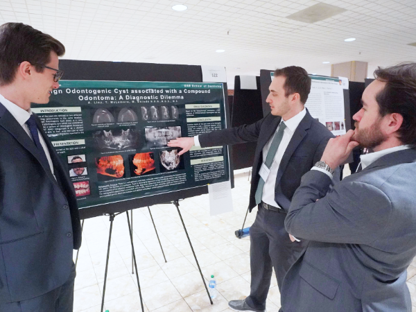 Three dental students presenting at last year's Scholar Symposium.