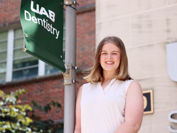 Sarah Lloyd with UAB Dentistry sign