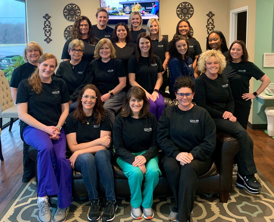 Mary Leigh Gillespie poses with a large group of coworkers. 