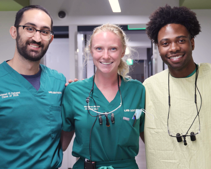 DMD students smiling in the clinic
