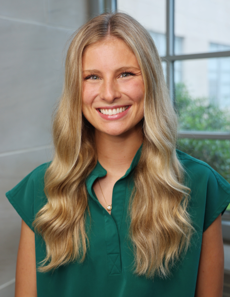 Smiling young woman in green scrubs