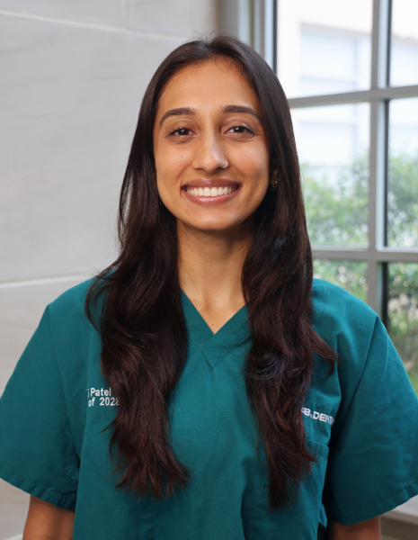 Smiling young woman in green scrubs
