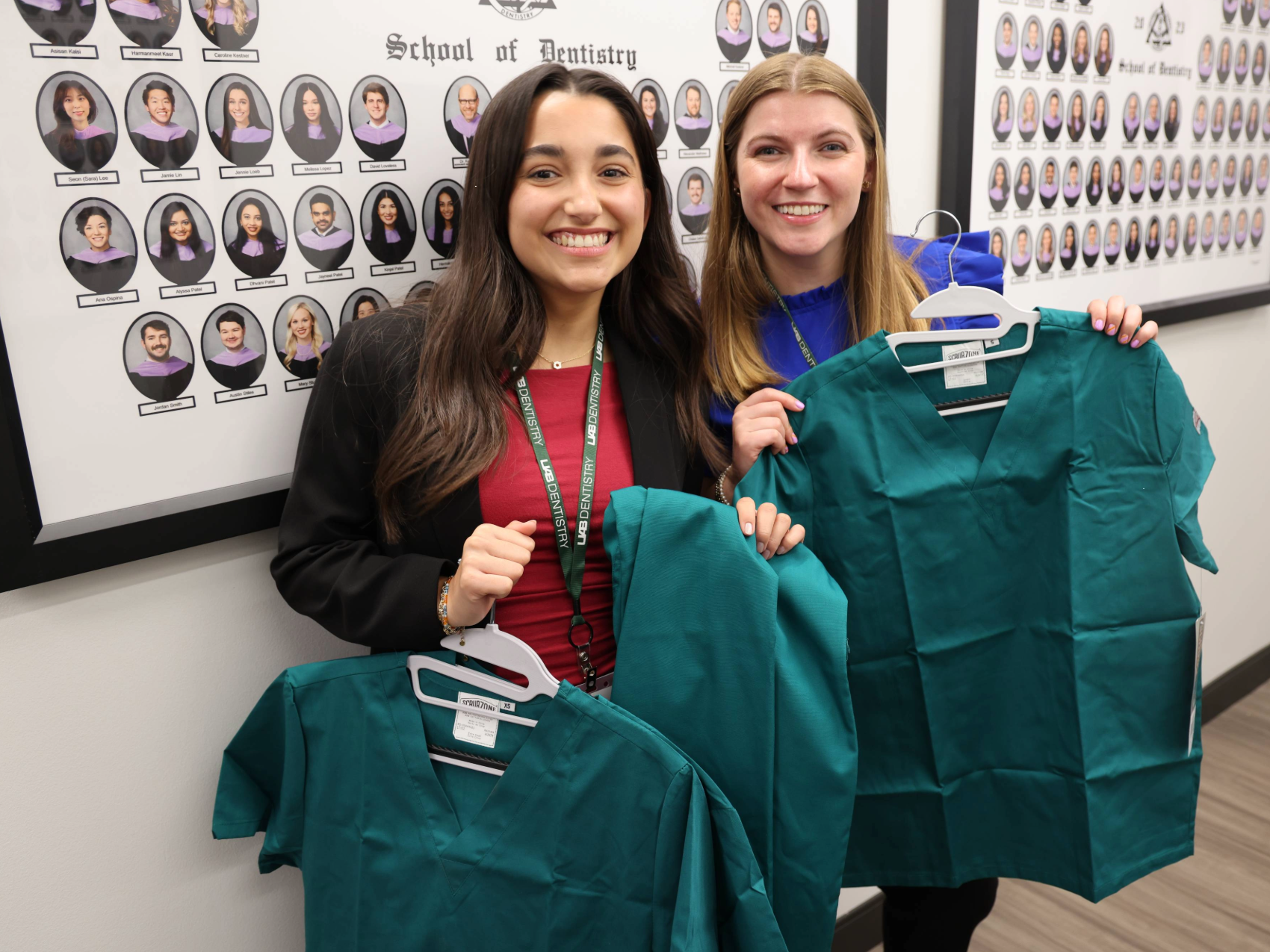 Two incoming D1 students participating holding scrubs on Welcome Day