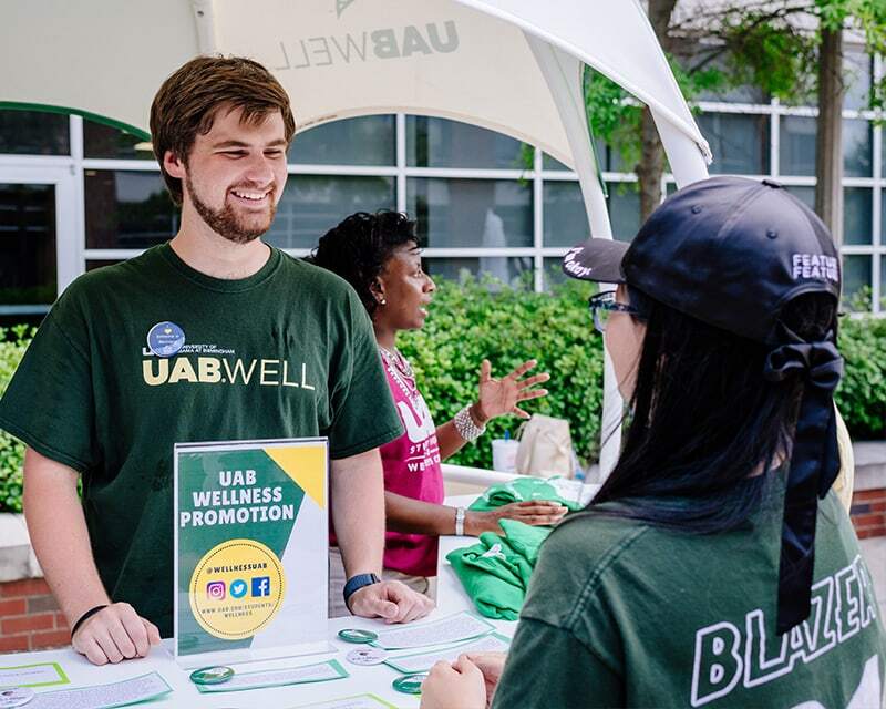 two people at a UAB wellness promotion booth
