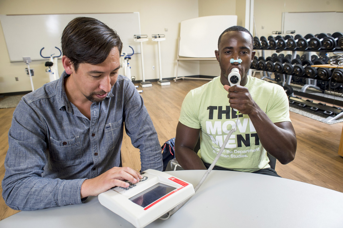 Kinesiology Student Breathing into Monitor