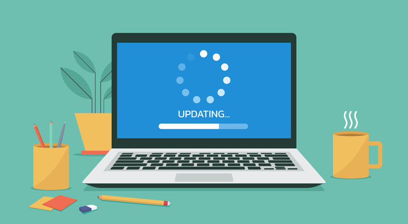 Illustration of a laptop displaying a half-completed "uploading" circle and bar. A coffee cup, potted plant, pencil cup, and other office supplies are around the laptop. 