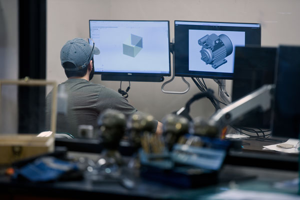 Student looking at models on a computer screen.