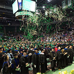 Students in caps and gowns celebrating.