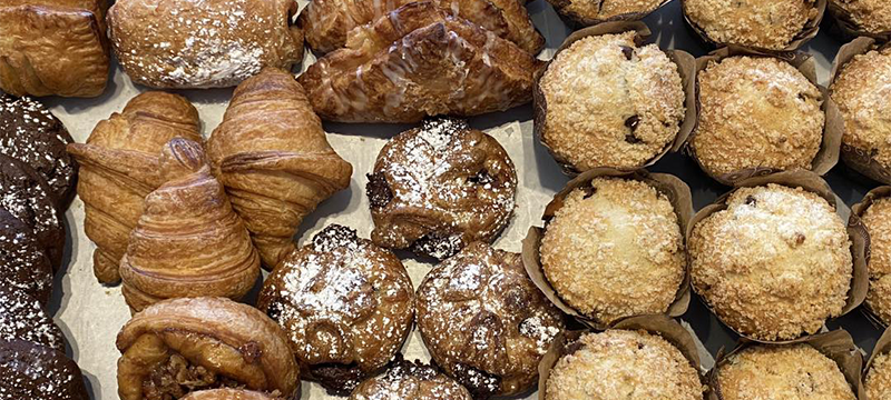 Up-close shot of muffins, croissants and pastries
