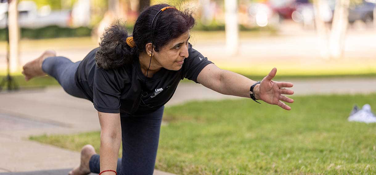 Woman doing yoga outdoors.