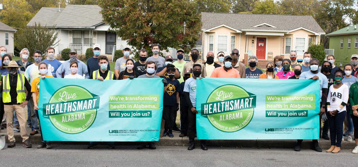 Live HealthSmart volunteers hold two large banners.