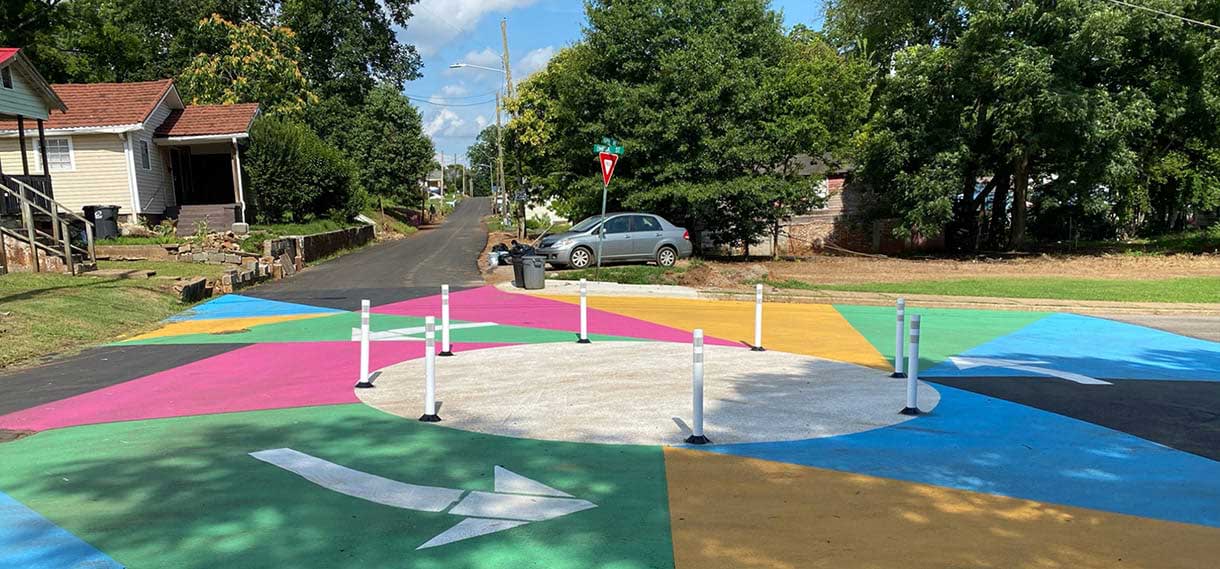 A bright multi-colored roundabout with arrows showing the driving direction.