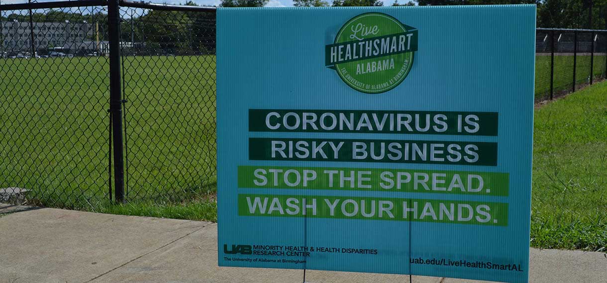A Live HealthSmart sign reading "Coronavirus is risky business. Stop the spread. Wash your hands."