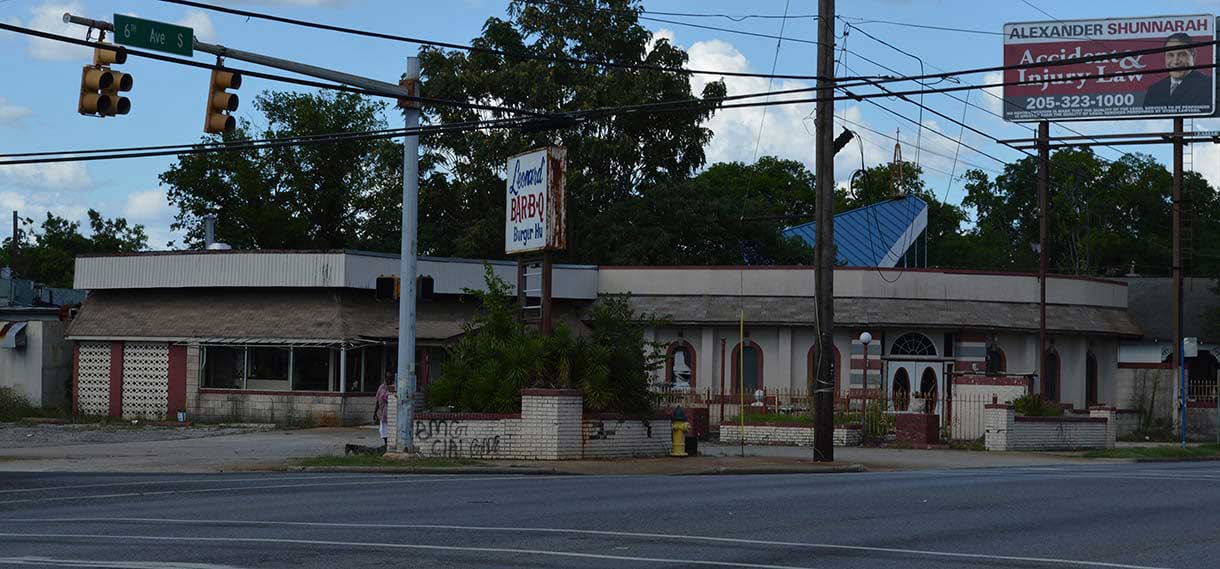 Closed BBQ restaurant with graffiti on one wall.