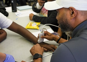 Close-up of Calvin Spellmon, M.D., operating a POCUS device