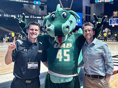 Dr. Matt Miesch and Dr. Heath Hale standing with Blaze at the quarterfinal victory over Vanderbilt