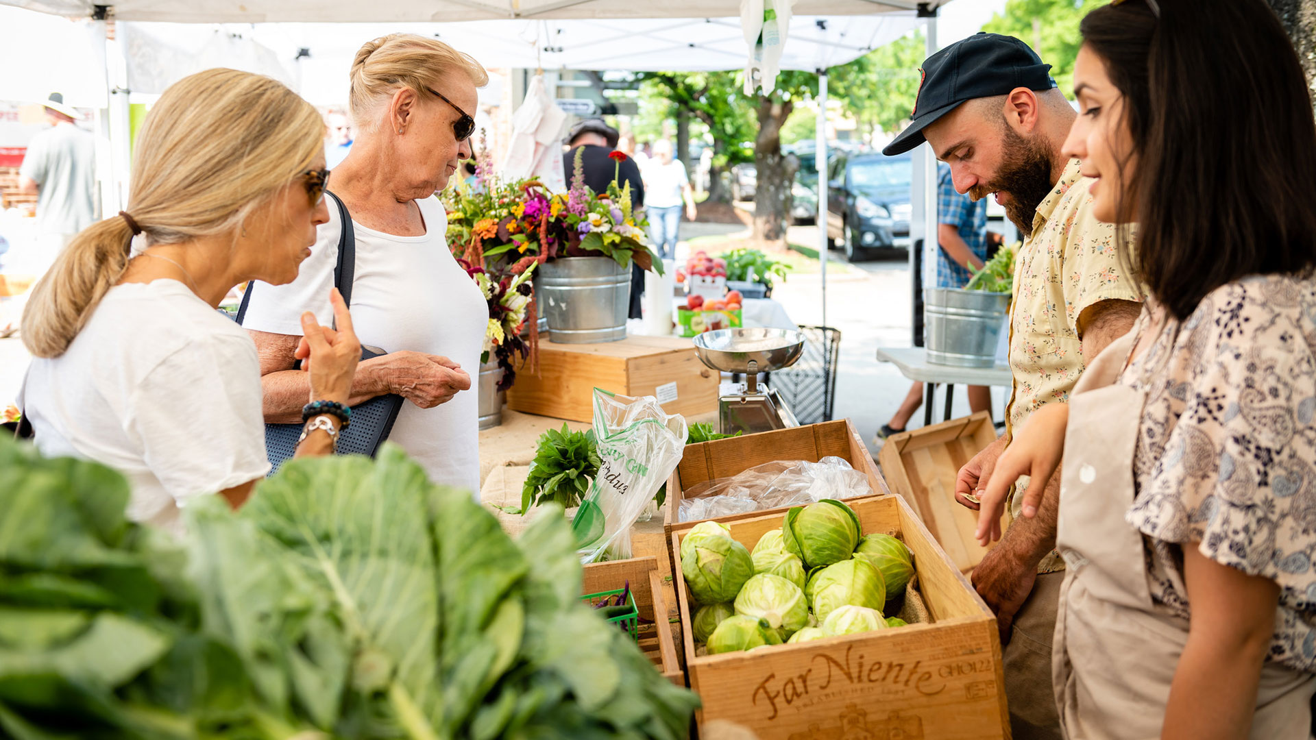 people and vegetables at farmers market