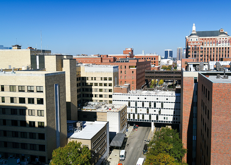 Drone photo over 19th St S showing the Birmingham Veterans Affairs(VA) Medical Center on the left, the Zeigler Research Building on the right, the Research Bridge, and UAB Hospital, Jefferson Tower, and downtown in the background, November 2023.