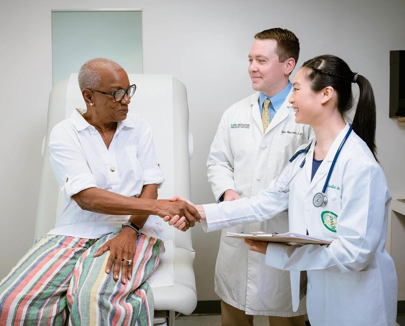 medical student shaking hands with patient