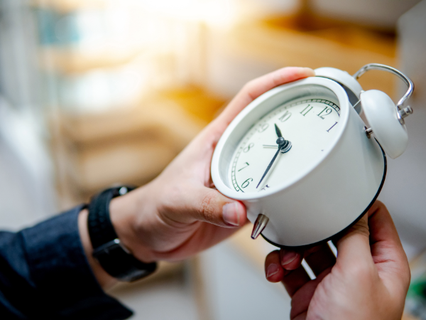 Person changing the time following the switch to Daylight Saving Time.