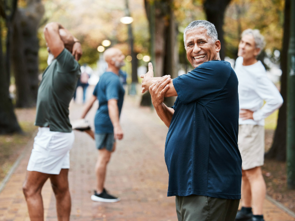group of people stretching in a park