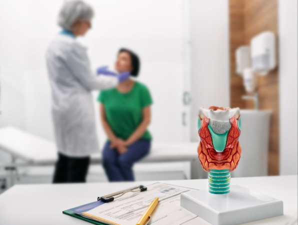 Physician doing thyroid exam