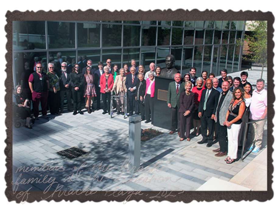 A group photo of around 40 members of the Kracke family, the UAB Dean Ray Watts, and Dean of The Heersink School of Medicine; Anupam Agarwal. They stand in a group around the sculpture of Dr. Kracke.