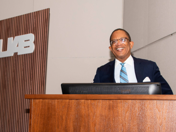Dr. Selwyn Vickers standing at podium