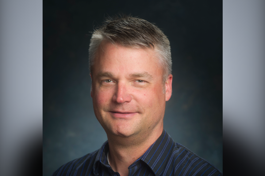 David Schneider head shot with a gray background