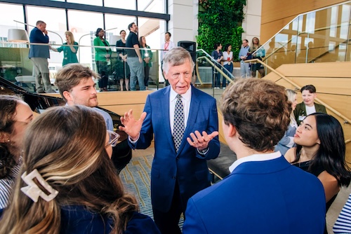 Dr. Heersink speaks with medical students in Volker Hall Atrium.