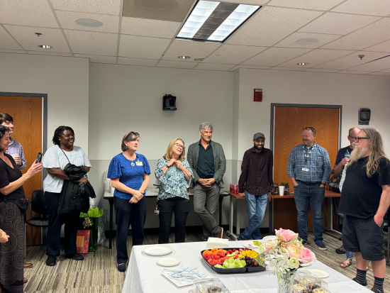 Julie Decker and a crowd gather at retirement party