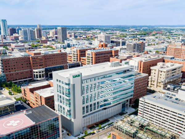 Drone photo showing the overall of the UAB Medical Campus buildings, with the skyscrapers of downtown Birmingham in the background.