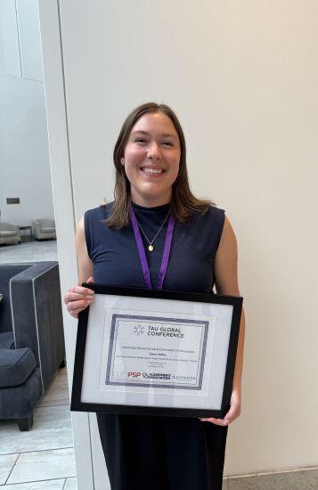 Emma Hobby, UAB GBS student, holding award