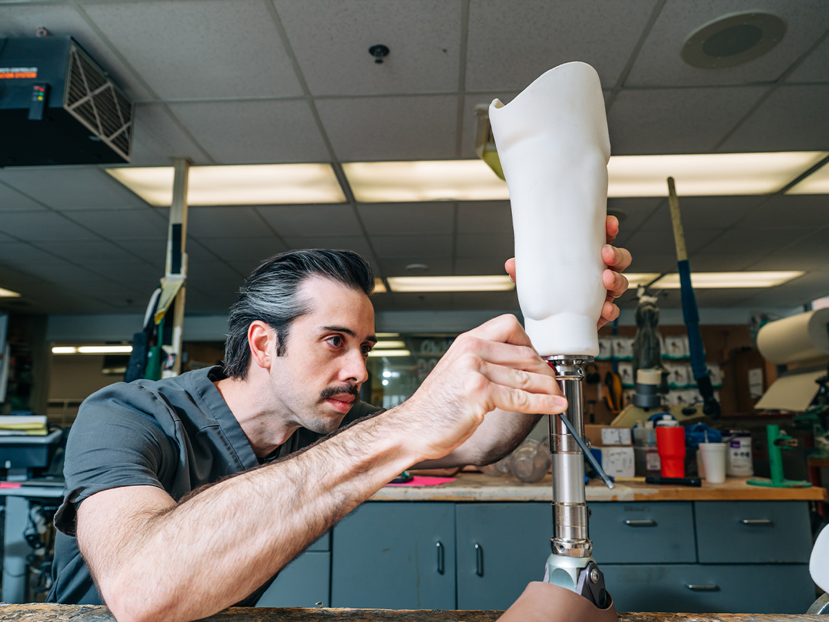 UAB prosthetist uses tool to adjust a prosthesis.